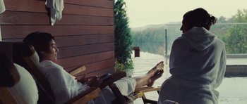 Movie still from “Café de Flore” (2011), directed by Jean-Marc Vallée – A person sitting on a chair next to a body of water; Medium shot, Over the shoulder angle