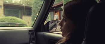 Movie still from “Café de Flore” (2011), directed by Jean-Marc Vallée – A woman sitting in the driver's seat of a car looking out the window; Close Up shot, Over the shoulder angle