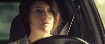 Movie still from “Café de Flore” (2011), directed by Jean-Marc Vallée – A person driving a car; Close Up shot, Low angle
