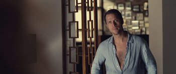 Movie still from “Café de Flore” (2011), directed by Jean-Marc Vallée – A man standing in front of a wooden screen; Medium shot, Over the shoulder angle