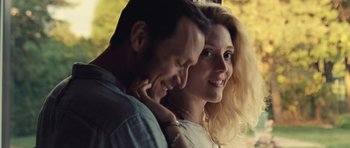 Movie still from “Café de Flore” (2011), directed by Jean-Marc Vallée – A man and a woman smiling for the camera; Close Up shot, Over the shoulder angle