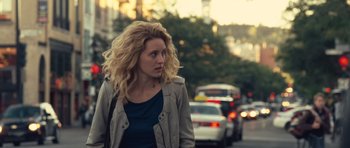 Movie still from “Café de Flore” (2011), directed by Jean-Marc Vallée – A woman is walking down the street in the city; Medium shot, Over the shoulder angle