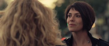 Movie still from “Café de Flore” (2011), directed by Jean-Marc Vallée – A woman looking at another woman in the street; Close Up shot, Over the shoulder angle