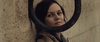 Movie still from “Café de Flore” (2011), directed by Jean-Marc Vallée – A woman with a large metal ring around her neck; Close Up shot, High angle