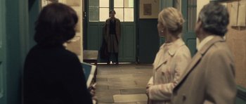 Movie still from “Café de Flore” (2011), directed by Jean-Marc Vallée – A woman standing in front of a door way; Wide shot, Over the shoulder angle
