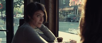 Movie still from “Café de Flore” (2011), directed by Jean-Marc Vallée – A woman sitting in front of a window with a cup of coffee; Close Up shot, Over the shoulder angle