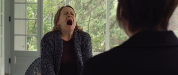 Movie still from “Café de Flore” (2011), directed by Jean-Marc Vallée – A woman sitting in front of another woman with her mouth wide open; Close Up shot, Over the shoulder angle