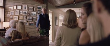 Movie still from “Café de Flore” (2011), directed by Jean-Marc Vallée – An older man standing in front of a woman in a living room; Medium shot, Over the shoulder angle