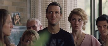 Movie still from “Café de Flore” (2011), directed by Jean-Marc Vallée – A man and two women standing next to each other in a room; Close Up shot, Over the shoulder angle