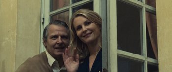 Movie still from “Café de Flore” (2011), directed by Jean-Marc Vallée – A man and a woman wave from a window; Close Up shot, Low angle