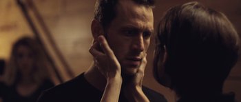Movie still from “Café de Flore” (2011), directed by Jean-Marc Vallée – A person touching his face; Close Up shot, Over the shoulder angle