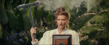 Movie still from “The Call of the Wild” (2020), directed by Chris Sanders – A woman holding an axe and an old fashioned camera; Close Up shot, Low angle
