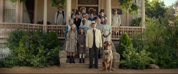 Movie still from “The Call of the Wild” (2020), directed by Chris Sanders – A group of people and a dog on the steps of a house; Wide shot, Low angle