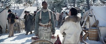 Movie still from “The Call of the Wild” (2020), directed by Chris Sanders – A man standing next to a woman on a snowy day; Medium shot, Over the shoulder angle