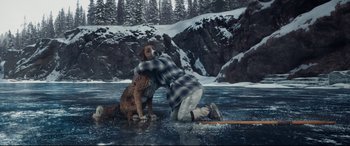 Movie still from “The Call of the Wild” (2020), directed by Chris Sanders – A man and a dog on a surfboard in the water; Wide shot, High angle