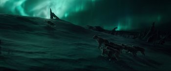 Movie still from “The Call of the Wild” (2020), directed by Chris Sanders – A group of dogs running on a snowy hill; Extreme Wide shot, High angle