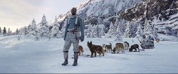 Movie still from “The Call of the Wild” (2020), directed by Chris Sanders – A man standing in the middle of a snow covered field; Wide shot, Low angle
