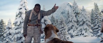 Movie still from “The Call of the Wild” (2020), directed by Chris Sanders – A man standing next to a dog in the snow; Medium shot, Over the shoulder angle