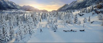 Movie still from “The Call of the Wild” (2020), directed by Chris Sanders – A man riding skis down the side of a snow covered slope; Extreme Wide shot, High angle