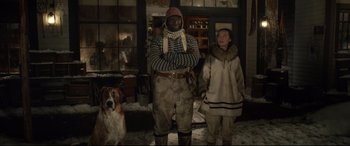 Movie still from “The Call of the Wild” (2020), directed by Chris Sanders – A man and a woman standing next to a dog; Medium shot, Low angle