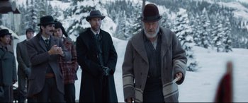 Movie still from “The Call of the Wild” (2020), directed by Chris Sanders – A man in a hat and a coat standing next to another man; Medium shot, Over the shoulder angle