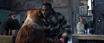 Movie still from “The Call of the Wild” (2020), directed by Chris Sanders – A man in a coat petting a brown bear; Close Up shot, Over the shoulder angle