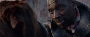 Movie still from “The Call of the Wild” (2020), directed by Chris Sanders – A man's face with a bear in the background; Close Up shot, Over the shoulder angle