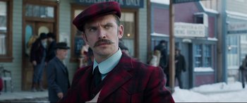 Movie still from “The Call of the Wild” (2020), directed by Chris Sanders – A man in a red and black plaid suit and hat; Close Up shot, Low angle