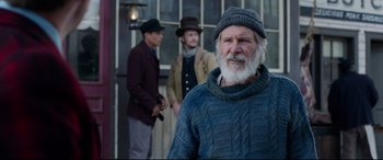 Movie still from “The Call of the Wild” (2020), directed by Chris Sanders – A man with a gray beard wearing a hat and a sweater; Medium shot, Over the shoulder angle