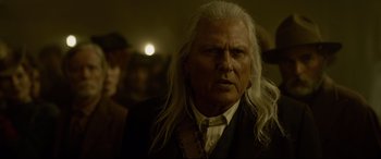 Movie still from “The Call of the Wild” (2020), directed by Chris Sanders – An old man with long white hair is looking at the camera; Close Up shot, Over the shoulder angle