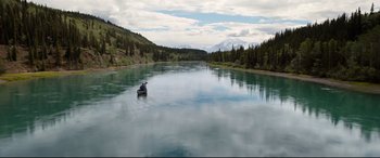 Movie still from “The Call of the Wild” (2020), directed by Chris Sanders – Two people in a boat on a river with mountains in the background; Extreme Wide shot, High angle