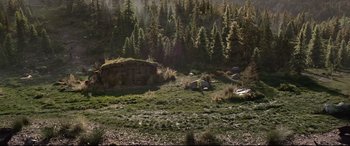 Movie still from “The Call of the Wild” (2020), directed by Chris Sanders – An old log cabin sits in the middle of a forest; Extreme Wide shot, High angle