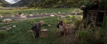 Movie still from “The Call of the Wild” (2020), directed by Chris Sanders – An old man sitting on a bench next to a dog; Wide shot, Over the shoulder angle