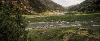 Movie still from “The Call of the Wild” (2020), directed by Chris Sanders – A river running through a lush green valley; Extreme Wide shot, High angle
