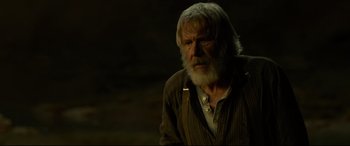 Movie still from “The Call of the Wild” (2020), directed by Chris Sanders – An old man with a beard is sitting in a dimly lit room; Close Up shot, Over the shoulder angle