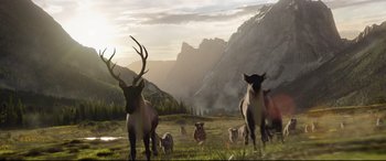 Movie still from “The Call of the Wild” (2020), directed by Chris Sanders – A herd of animals standing on top of a grass covered field; Wide shot, Low angle