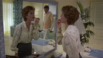 Movie still from “California Suite” (1978), directed by Herbert Ross – A woman brushing her teeth in front of a mirror; Medium shot, Over the shoulder angle