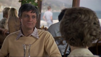 Movie still from “California Suite” (1978), directed by Herbert Ross – A man sitting in front of another man at a table; Close Up shot, Over the shoulder angle