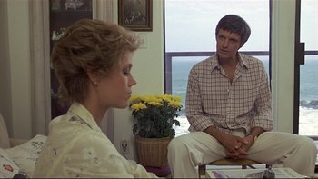 Movie still from “California Suite” (1978), directed by Herbert Ross – A man and a woman sitting next to each other; Medium shot, Over the shoulder angle