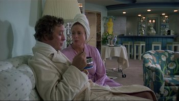 Movie still from “California Suite” (1978), directed by Herbert Ross – A man and a woman sitting on a bed; Medium shot, Over the shoulder angle