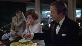 Movie still from “California Suite” (1978), directed by Herbert Ross – A man in a tuxedo and a woman in a white dress; Medium shot, Over the shoulder angle