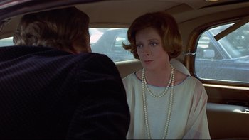 Movie still from “California Suite” (1978), directed by Herbert Ross – A woman sitting in the back seat of a car talking to a man; Close Up shot, Over the shoulder angle