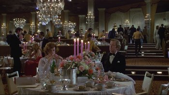 Movie still from “California Suite” (1978), directed by Herbert Ross – A man and a woman sitting at a dinner table; Wide shot, High angle