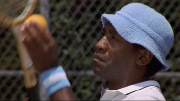 Movie still from “California Suite” (1978), directed by Herbert Ross – A person holding an apple; Close Up shot, Low angle