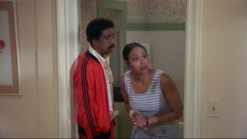 Movie still from “California Suite” (1978), directed by Herbert Ross – A man and a woman are standing in a bathroom; Medium shot, Over the shoulder angle