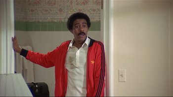 Movie still from “California Suite” (1978), directed by Herbert Ross – A man in a white shirt and a red jacket; Medium shot, Low angle