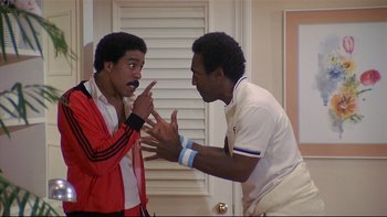 Movie still from “California Suite” (1978), directed by Herbert Ross – Two young men are arguing in a living room; Medium shot, Low angle