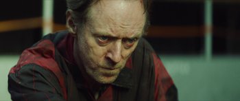 Movie still from “Calm with Horses” (2019), directed by Nick Rowland – An older man with a sad look on his face; Close Up shot, Over the shoulder angle