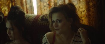 Movie still from “Calm with Horses” (2019), directed by Nick Rowland – A person sitting on a couch; Close Up shot, Over the shoulder angle