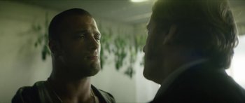 Movie still from “Calm with Horses” (2019), directed by Nick Rowland – Two men are facing each other in a room; Close Up shot, Over the shoulder angle